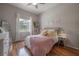 Cozy bedroom with hardwood floors, a plush blanket, lots of pillows and natural light at 23268 Family Ln, Brooksville, FL 34602