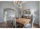 Formal dining room featuring a wooden table, decorative lighting, and access to other rooms at 23268 Family Ln, Brooksville, FL 34602
