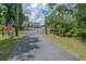 Gated driveway with an American flag, providing privacy and security at 23268 Family Ln, Brooksville, FL 34602