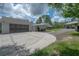 Side view of the garage, carport, and long driveway of this lovely home on acreage in the country at 23268 Family Ln, Brooksville, FL 34602