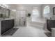 Bright main bathroom featuring a tiled shower, large tub, and double vanity sinks at 23268 Family Ln, Brooksville, FL 34602