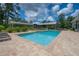 Backyard swimming pool with integrated hot tub and poolside pavilion at 23268 Family Ln, Brooksville, FL 34602