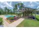 Poolside pavillion with outdoor cooking area overlooking the pool and backyard at 23268 Family Ln, Brooksville, FL 34602