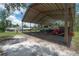 Covered storage area is big enough to house a travel trailer, tractor, and other equipment; perfect for country living at 23268 Family Ln, Brooksville, FL 34602