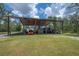 View of the large covered storage area, perfect for storing farm equipment, campers, or other outdoor vehicles at 23268 Family Ln, Brooksville, FL 34602
