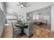 View of sun room with attached kitchen and living room, ceiling fans, and hardwood floors at 23268 Family Ln, Brooksville, FL 34602