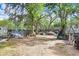 Spacious backyard area with mature trees, providing shade and a natural setting at 10044 Oana St, New Port Richey, FL 34654