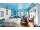 Bedroom featuring blue walls, small bed, window and gaming chair at 10044 Oana St, New Port Richey, FL 34654