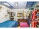 Small bedroom with a blue ceiling, an air conditioner in the window, and a closet with clothes at 10044 Oana St, New Port Richey, FL 34654