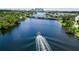 An aerial view of a river with a boat, bridge, and city skyline, showcasing a vibrant waterfront community at 1015 W Charter St, Tampa, FL 33602
