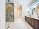 Sleek bathroom featuring a glass-enclosed shower, double vanity, and neutral color palette at 1015 W Charter St, Tampa, FL 33602