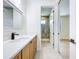 Bathroom featuring wood cabinets, quartz countertops, modern fixtures and walk-in shower at 1015 W Charter St, Tampa, FL 33602