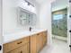 Bathroom featuring wood cabinets, quartz countertops, modern fixtures and walk-in shower at 1015 W Charter St, Tampa, FL 33602