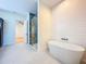 Charming bathroom with soaking tub and a view to an adjacent bonus room at 1015 W Charter St, Tampa, FL 33602