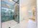 Contemporary bathroom with glass shower, soaking tub, and access to walk-in closet at 1015 W Charter St, Tampa, FL 33602