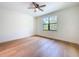 Sunlit bedroom with wood floors, a ceiling fan, and a view of the outdoors at 1015 W Charter St, Tampa, FL 33602