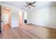 Spacious bedroom with wood flooring and a ceiling fan, featuring multiple entryways at 1015 W Charter St, Tampa, FL 33602