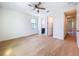 Bright bedroom featuring hardwood floors, ceiling fan, and ensuite bathroom access at 1015 W Charter St, Tampa, FL 33602