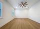 Spacious bedroom with hardwood floors, a contemporary ceiling fan, and bright natural light at 1015 W Charter St, Tampa, FL 33602