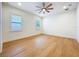 Bright bedroom featuring hardwood floors, ample natural light, and a modern ceiling fan at 1015 W Charter St, Tampa, FL 33602