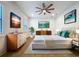 Well-lit bedroom with contemporary decor, light wood floors, ceiling fan, and a large window at 1015 W Charter St, Tampa, FL 33602