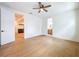 Large bedroom featuring hardwood floors, ceiling fan, and doors leading to other rooms at 1015 W Charter St, Tampa, FL 33602