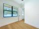 Bedroom featuring hardwood floors and a large window with backyard view at 1015 W Charter St, Tampa, FL 33602