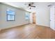 Bright bedroom featuring hardwood floors, two windows, ceiling fan and a walk-in closet at 1015 W Charter St, Tampa, FL 33602