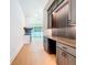 Hallway with custom built-in cabinets and shelves; view to an open concept living space at 1015 W Charter St, Tampa, FL 33602