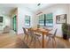 Bright dining room features light wood floors, a modern light fixture, and windows with outdoor views at 1015 W Charter St, Tampa, FL 33602