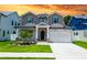 Charming two-story home featuring stone accents, a well-manicured lawn, and a two-car garage at 1015 W Charter St, Tampa, FL 33602