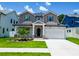 Charming two-story home featuring stone accents, a well-manicured lawn, and a two-car garage at 1015 W Charter St, Tampa, FL 33602
