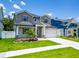 Charming two-story home boasts a manicured lawn, complemented by a paved walkway, perfect for curb appeal at 1015 W Charter St, Tampa, FL 33602