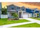 Charming two-story home boasts a manicured lawn, complemented by a paved walkway, perfect for curb appeal at 1015 W Charter St, Tampa, FL 33602