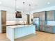 Bright kitchen featuring a center island, stainless steel appliances, and modern pendant lighting at 1015 W Charter St, Tampa, FL 33602