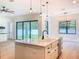 Open-concept kitchen with a farmhouse sink, stainless steel appliances, and sliding glass doors to the backyard at 1015 W Charter St, Tampa, FL 33602