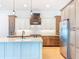 Modern kitchen boasts two-tone cabinetry, stainless steel appliances, and a large center island at 1015 W Charter St, Tampa, FL 33602