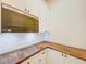 White kitchen cabinetry, butcher block countertops, subway tile backsplash and stainless steel microwave at 1015 W Charter St, Tampa, FL 33602