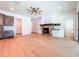 Bright living room featuring a stone fireplace, wooden floors and a modern ceiling fan at 1015 W Charter St, Tampa, FL 33602