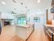 Open-concept living room and kitchen with a stone fireplace, stainless steel appliances, and a center island at 1015 W Charter St, Tampa, FL 33602