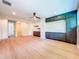 Open-concept living room with hardwood floors and custom built-in shelving at 1015 W Charter St, Tampa, FL 33602