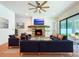 Cozy living room features a stone fireplace, a ceiling fan, and sliding doors to the outdoor patio at 1015 W Charter St, Tampa, FL 33602