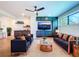 Bright and spacious living room with comfortable seating, a ceiling fan, and built-in storage at 1015 W Charter St, Tampa, FL 33602