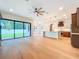 Open-concept living space with hardwood floors, flowing into a modern kitchen and outdoor views at 1015 W Charter St, Tampa, FL 33602