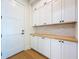 Mud room with white cabinetry, butcher block counters and dark hardware accents at 1015 W Charter St, Tampa, FL 33602