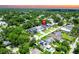 An aerial view showcases the property location within a mature, tree-filled neighborhood at sunset at 1015 W Charter St, Tampa, FL 33602