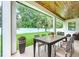 Covered patio with an outdoor dining area and a view of the landscaped backyard at 1015 W Charter St, Tampa, FL 33602