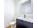 Chic powder room with navy vanity, modern faucet, and elegant mirror at 1015 W Charter St, Tampa, FL 33602