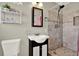 Bathroom with a modern vanity, tiled shower, and a decorative shelf, offering a functional and stylish space at 1029 Madison St, Largo, FL 33770