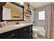 Modern bathroom with black vanity, marble-look shower, and decorative mirror at 1029 Madison St, Largo, FL 33770